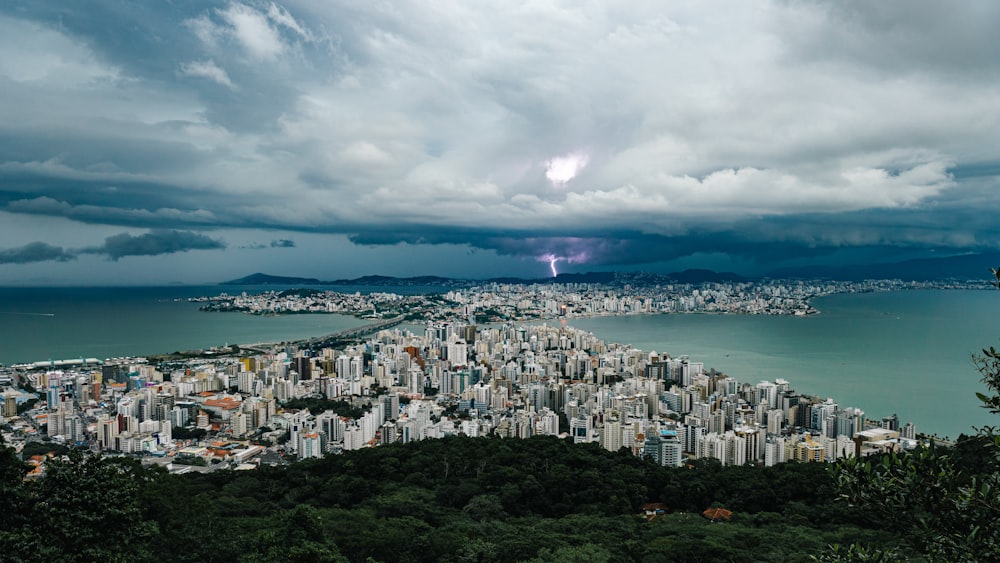 a view of a city and a body of water under a cloudy sky