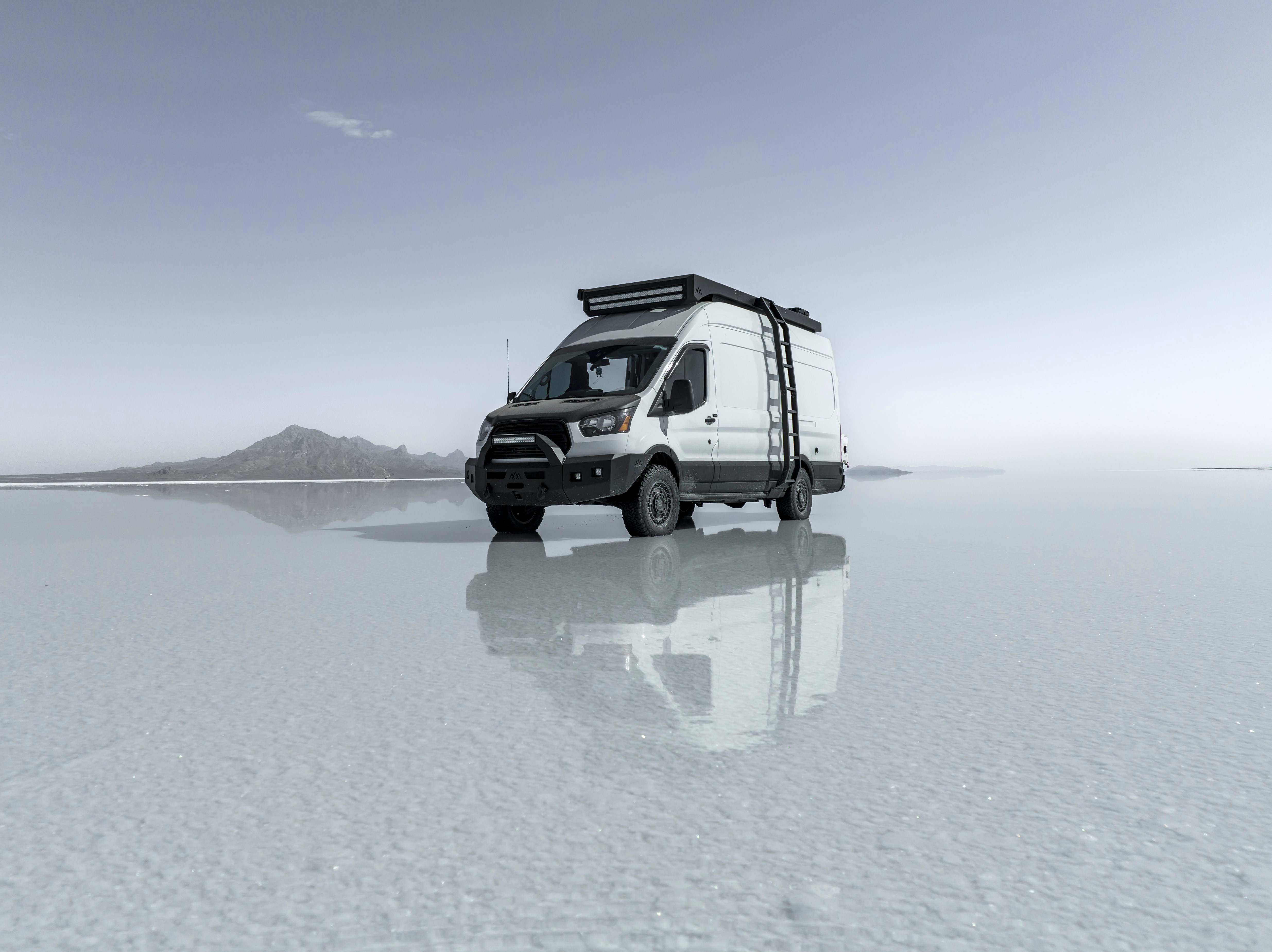 a black and white van parked on a flat surface