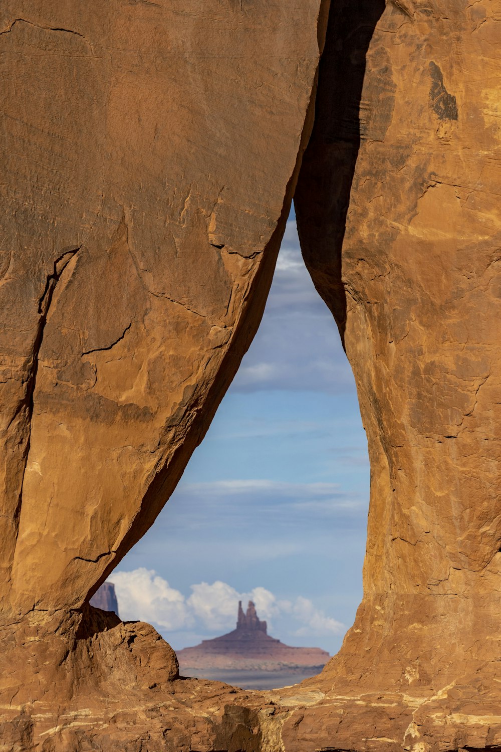 a rock formation with a view of a mountain in the distance