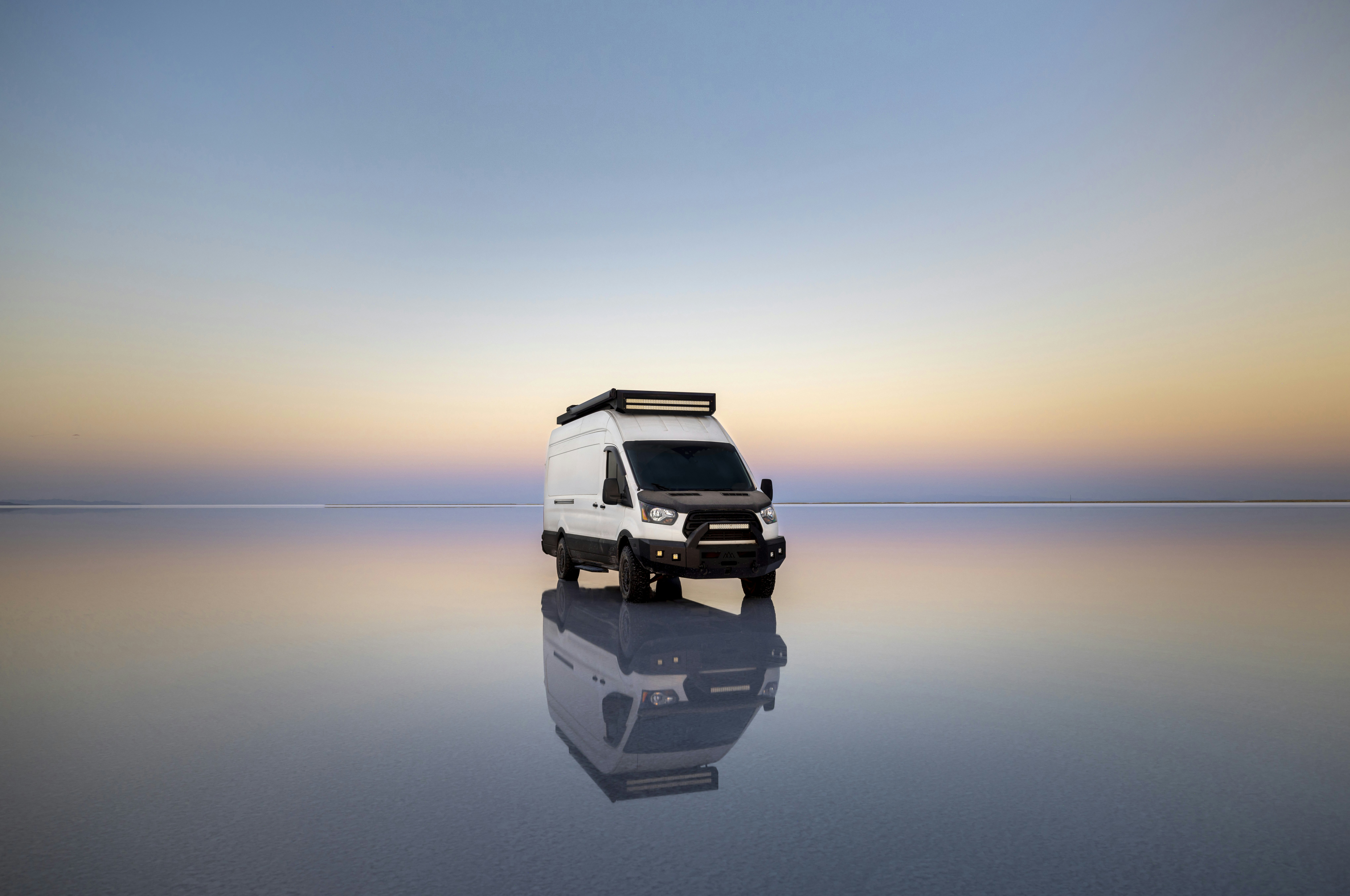 a van is parked in the middle of a large body of water