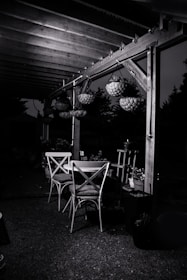 An elegant outdoor dining setup under a stylish pergola.