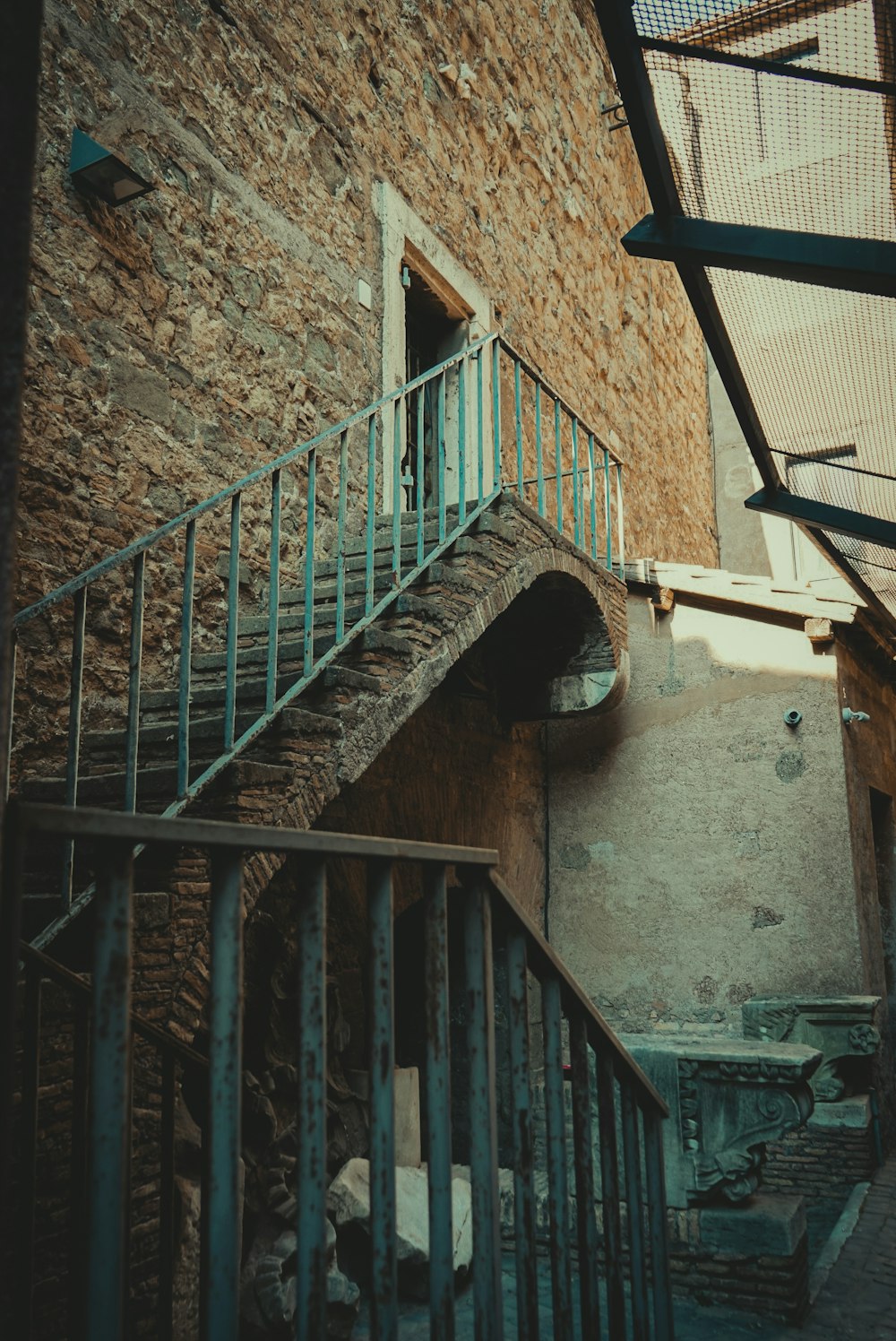 a stair case next to a brick building