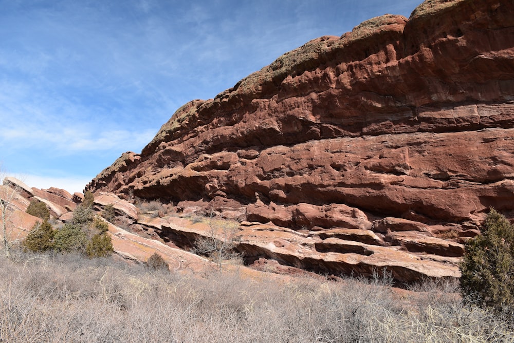 a large rock formation in the middle of a field