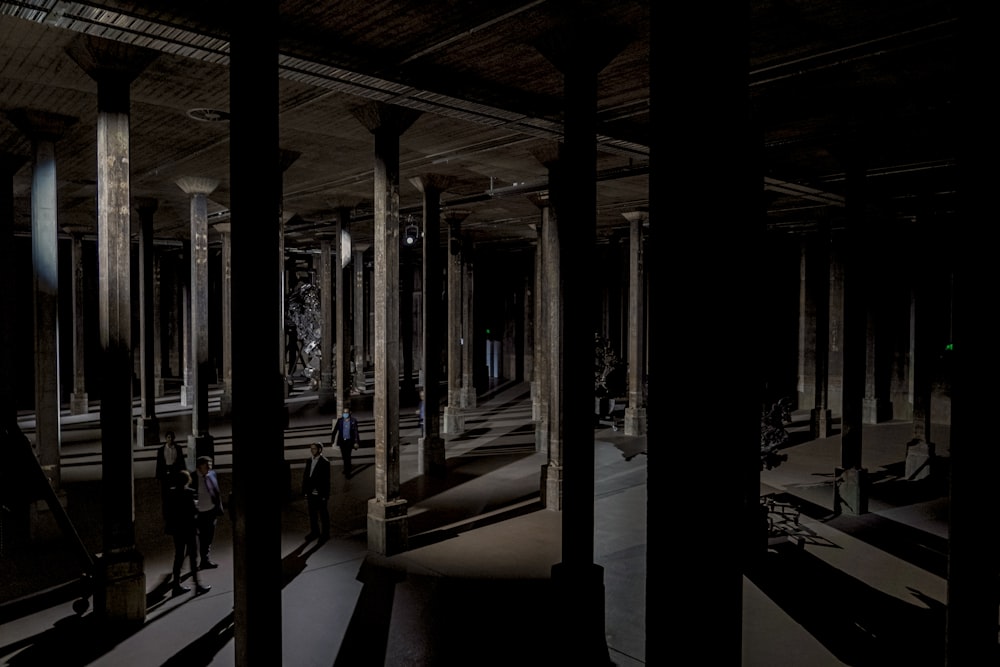 a group of people standing in a dark room