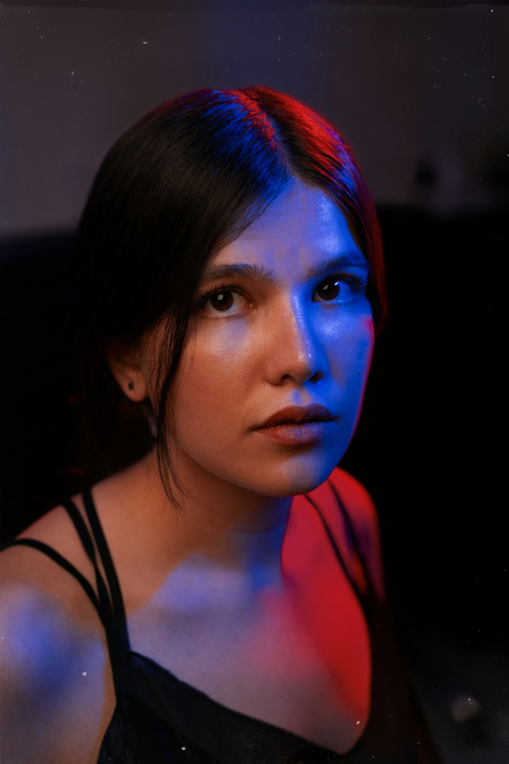 a woman with red and blue light on her face