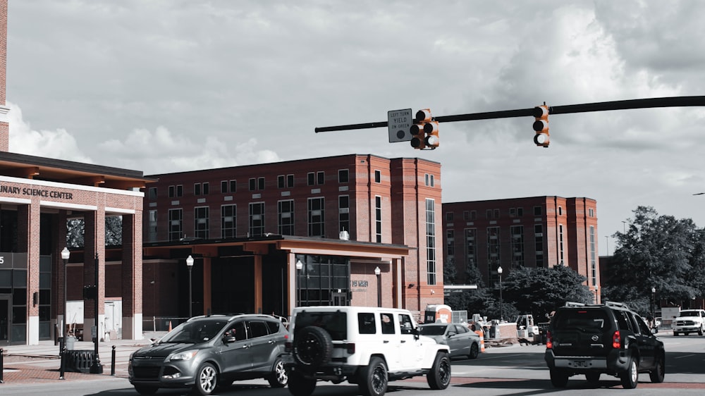 a traffic light over a street filled with cars