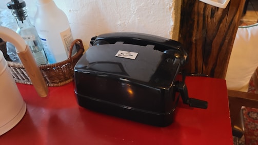 A cozy kitchen corner with a vintage rotary phone and a notebook ready for messages.