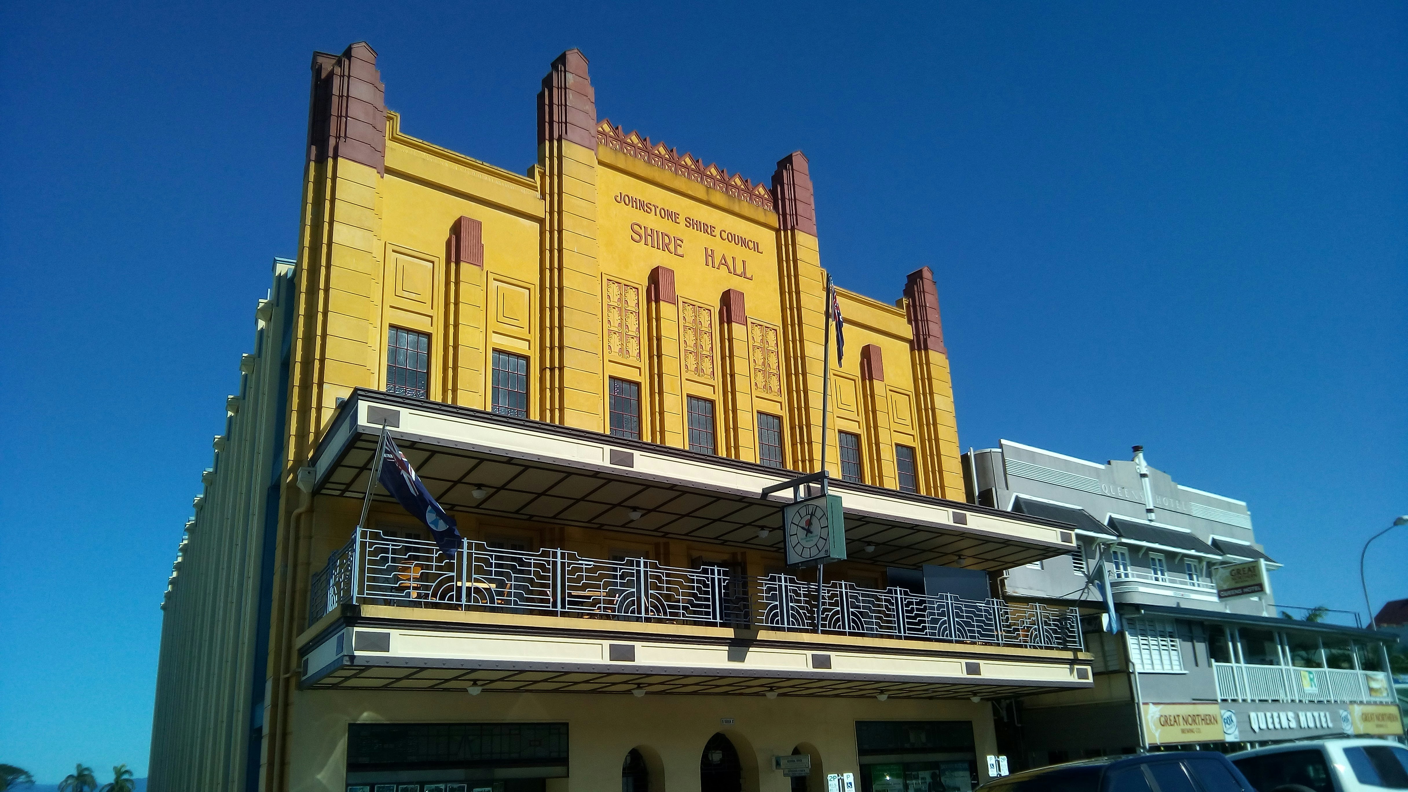 a large yellow building with a balcony and balconies