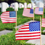 A close-up of a folded American flag resting gently on a soldier’s grave.