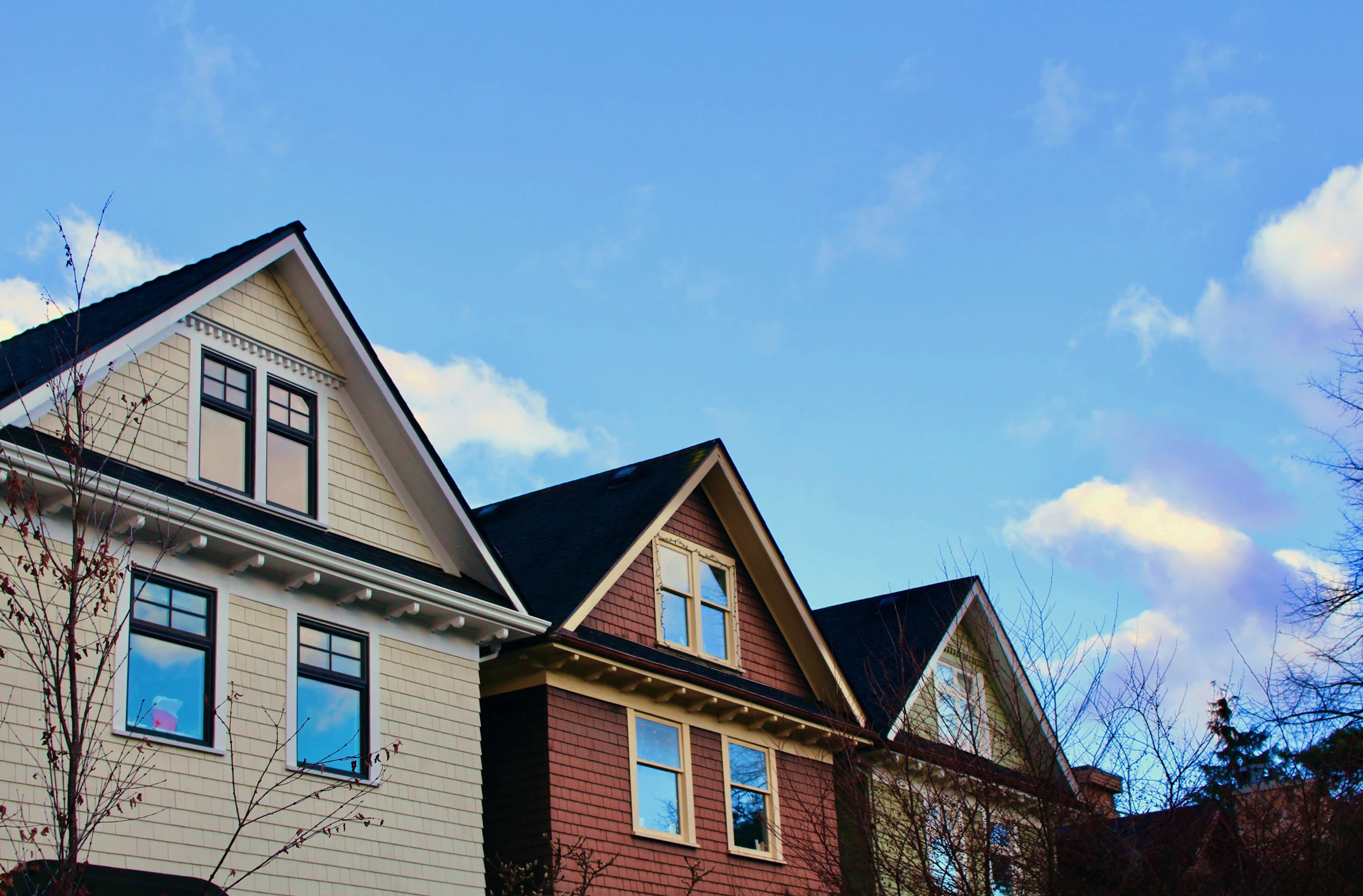 Bright blue sky over a well-kept residential neighborhood