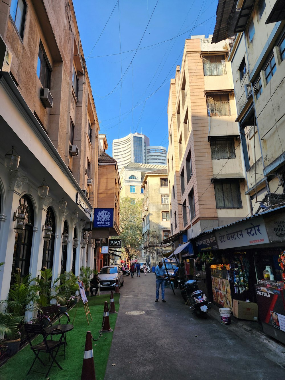 a narrow city street lined with tall buildings