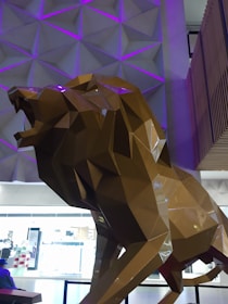 A sleek 3D printed lion figurine with metallic silver and purple accents.