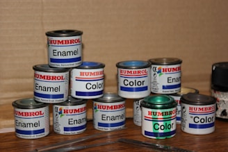 a group of paint cans sitting on top of a wooden table