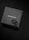 A pair of black textured rings is placed on top of a dark, sleek box. The box features the brand name 'COPPERTIST.WU' printed in gold letters.