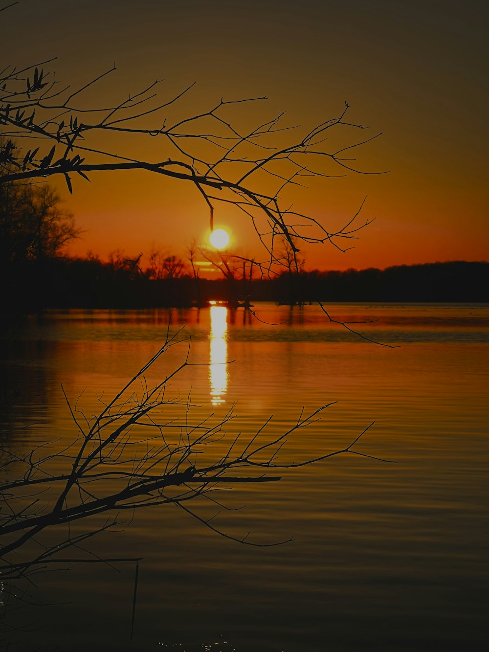 the sun is setting over a body of water