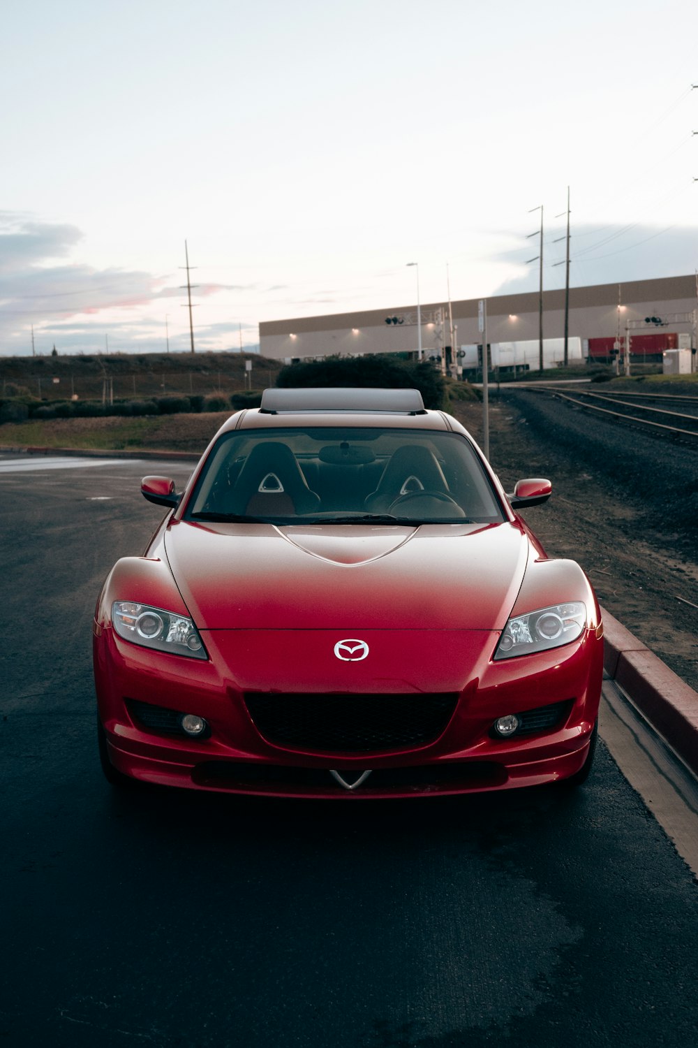 a red sports car parked on the side of the road