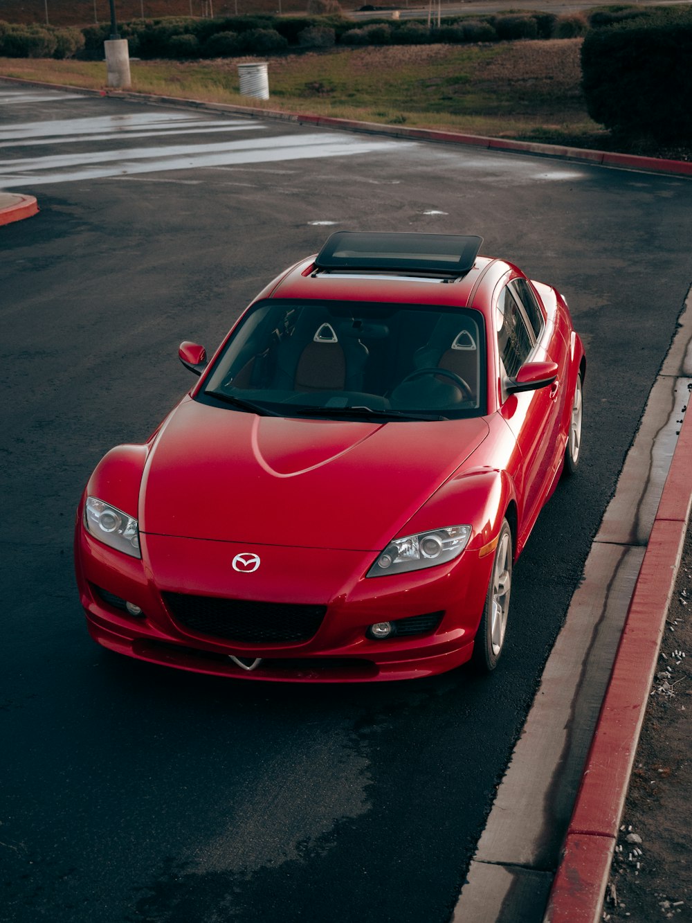 a red sports car parked on the side of the road