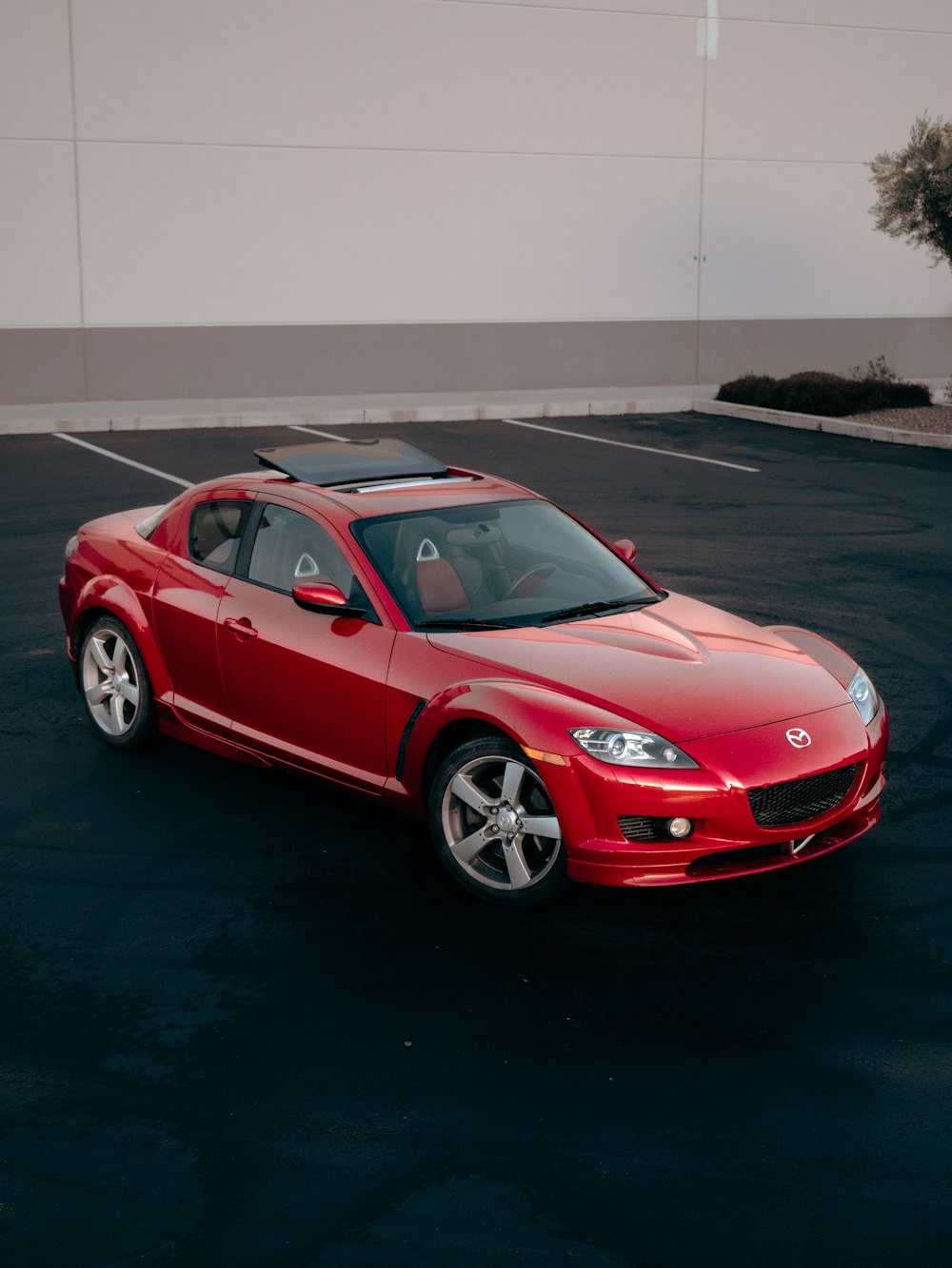 a red sports car parked in a parking lot