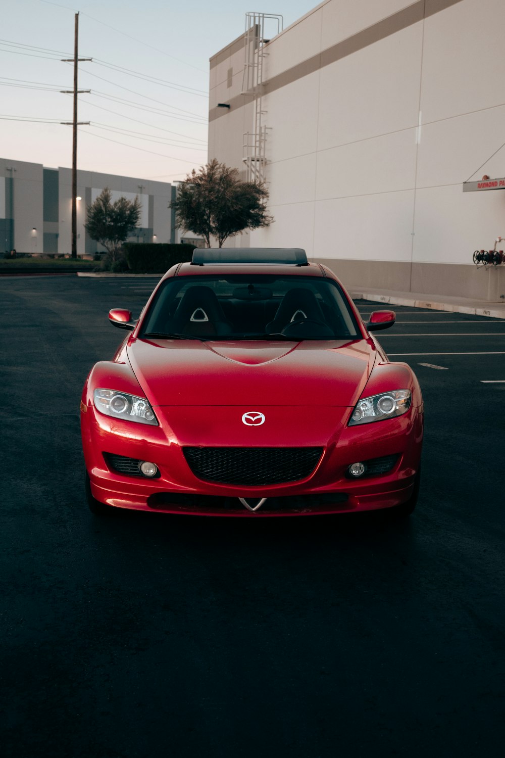 a red sports car parked in a parking lot