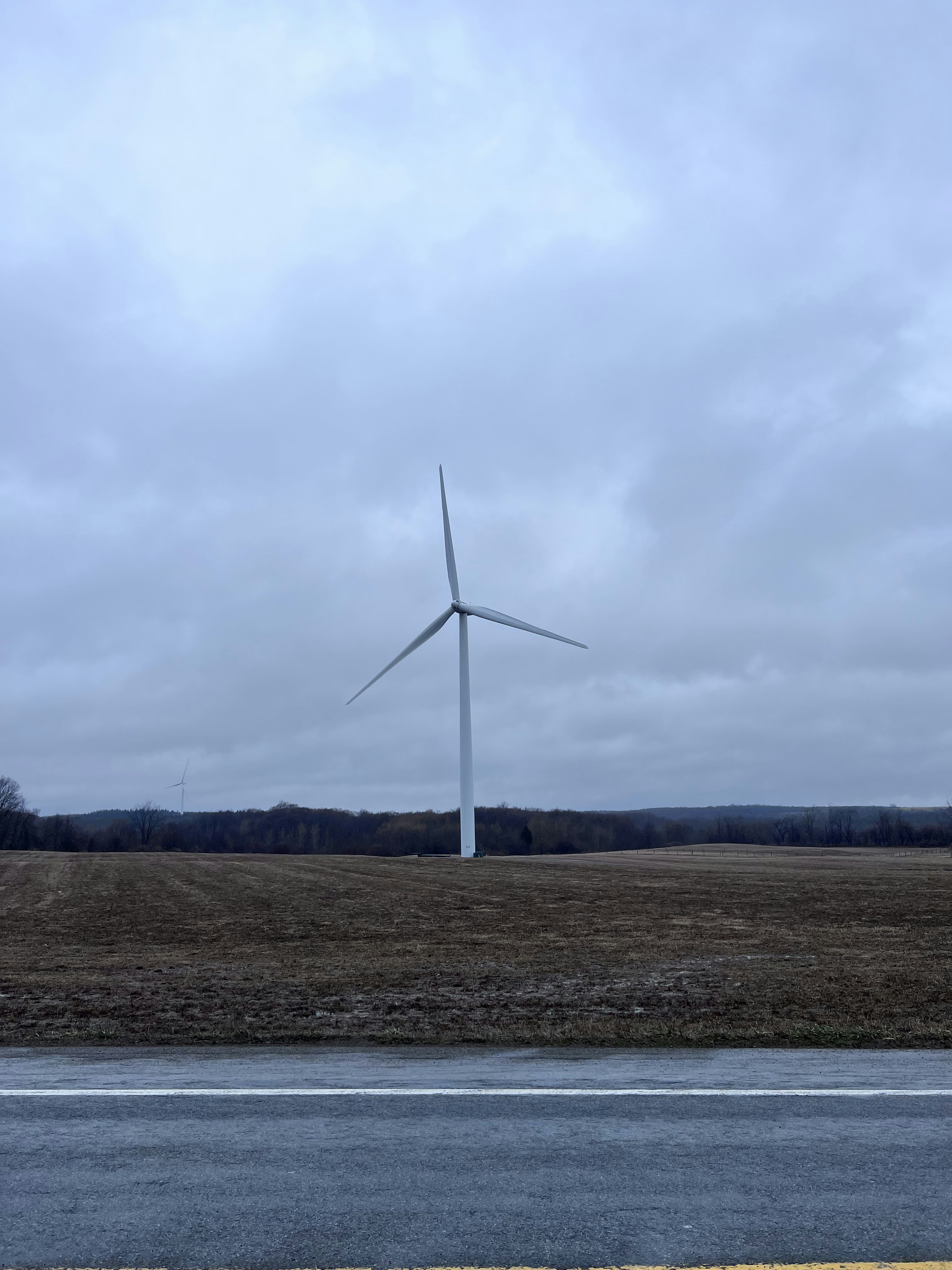 a wind turbine in the middle of a field