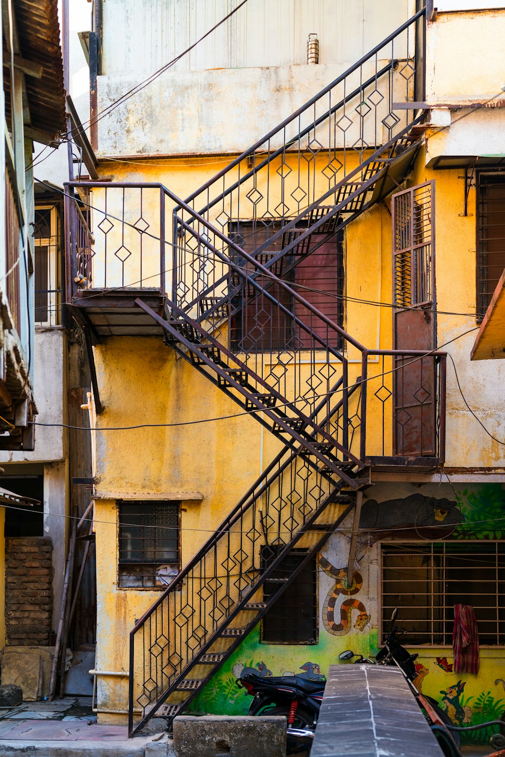 a set of stairs leading up to a yellow building