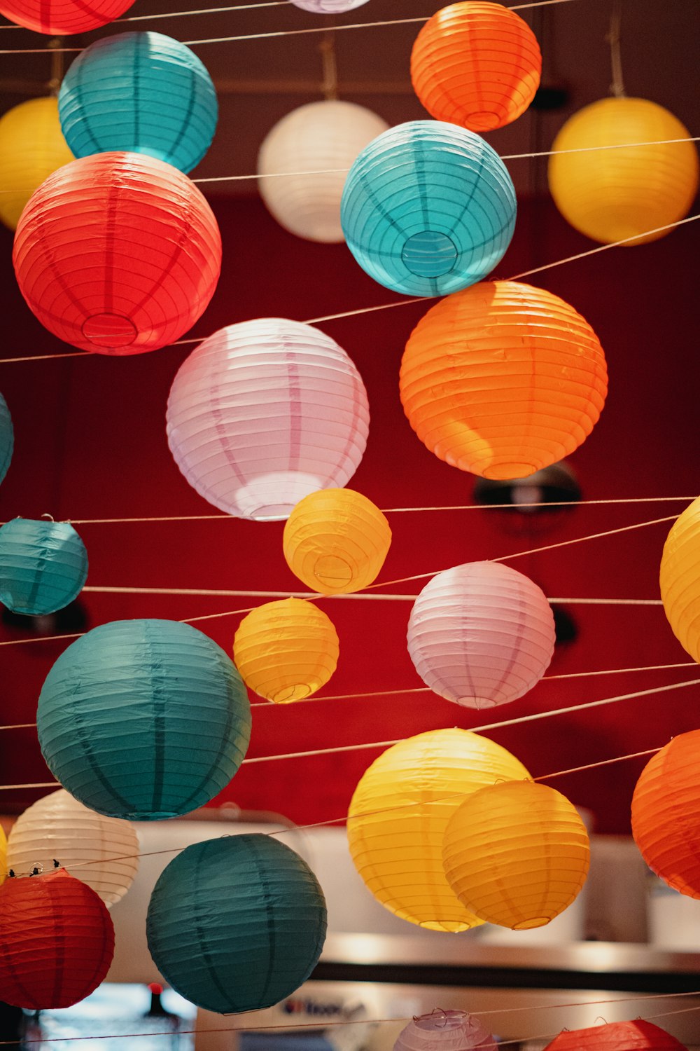 a room filled with lots of colorful paper lanterns