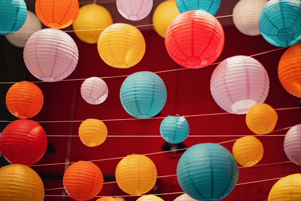 a bunch of paper lanterns hanging from a line