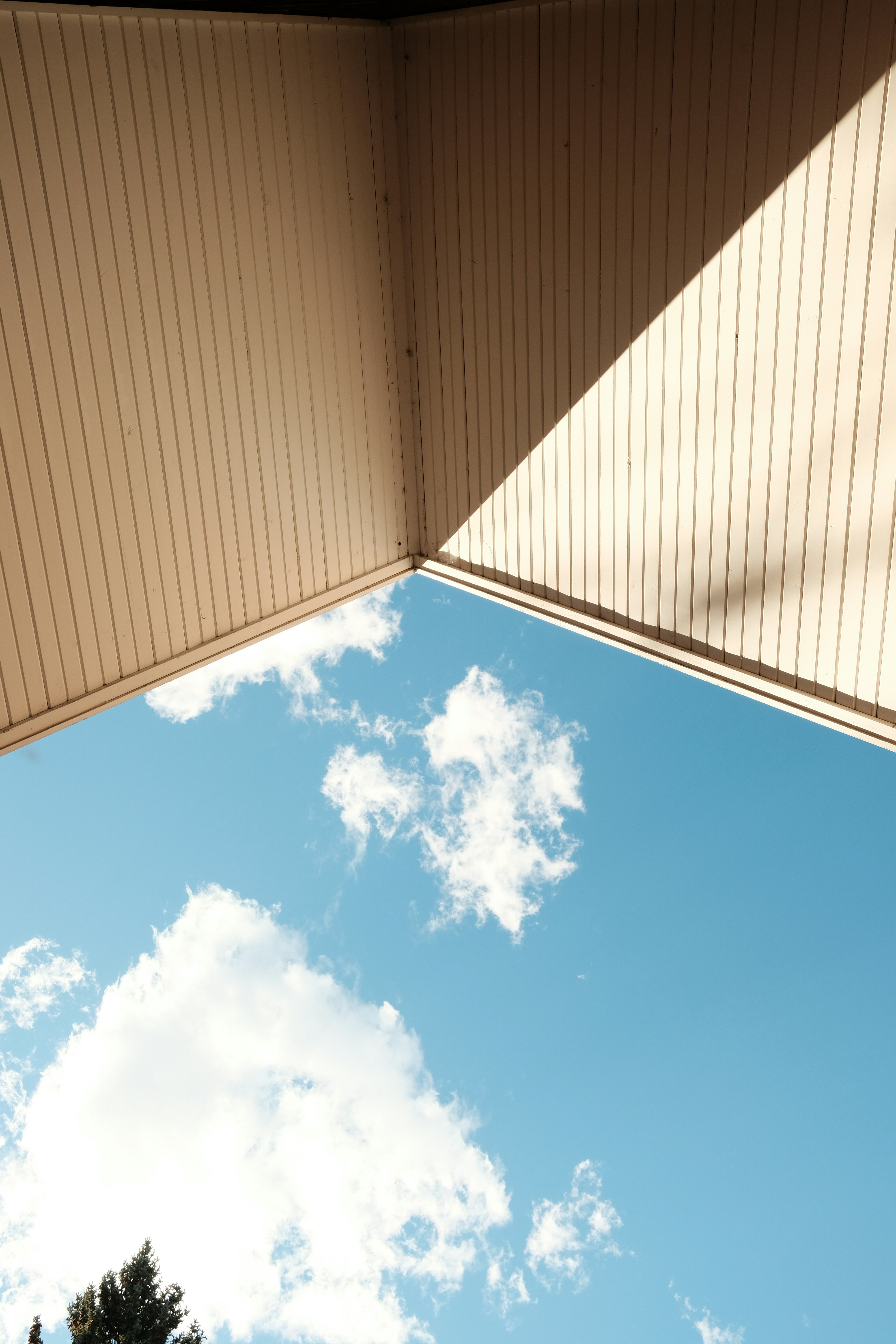 a view of the sky from underneath a building