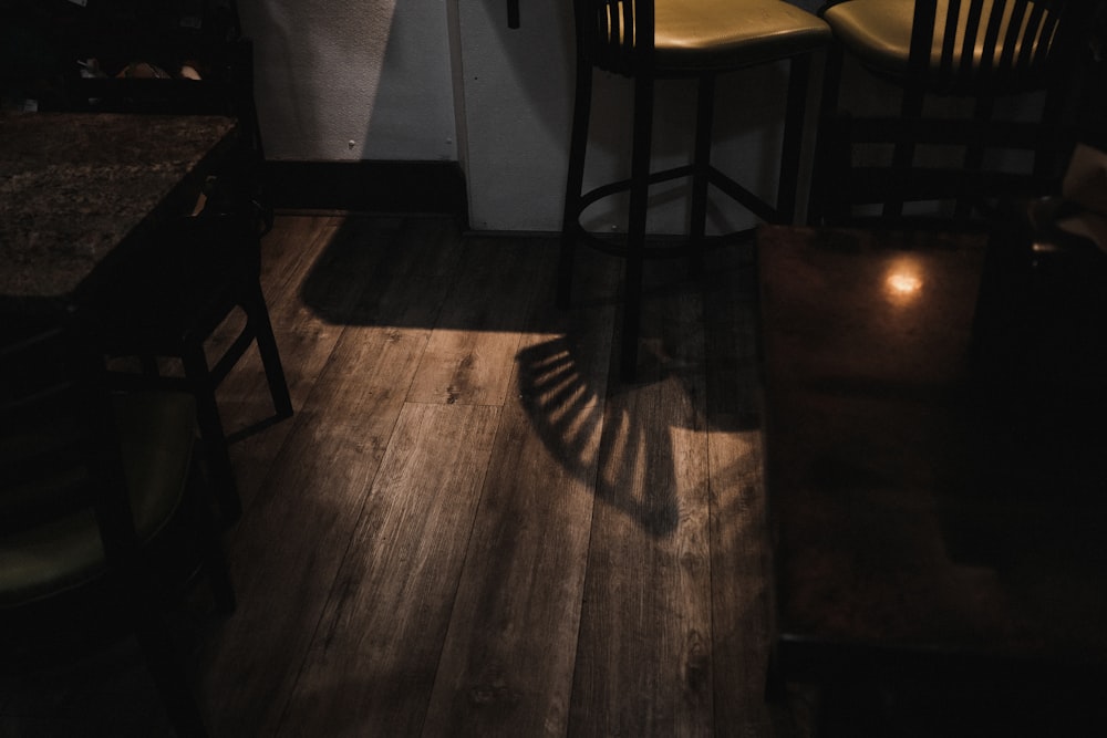 a dark room with a table and chairs