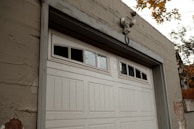 a white garage door on a brick building