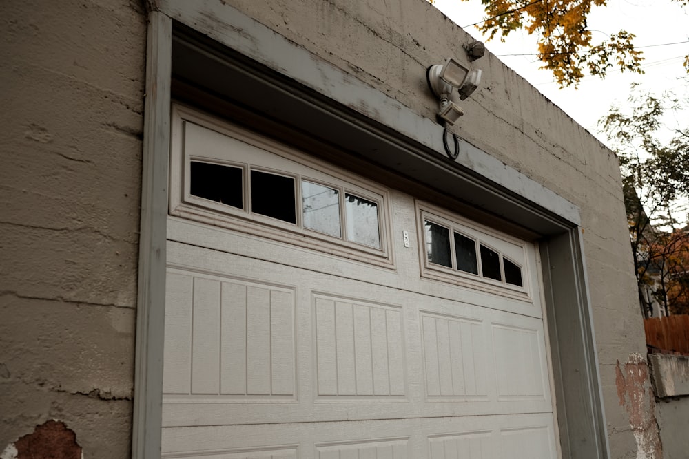 a white garage door on a brick building