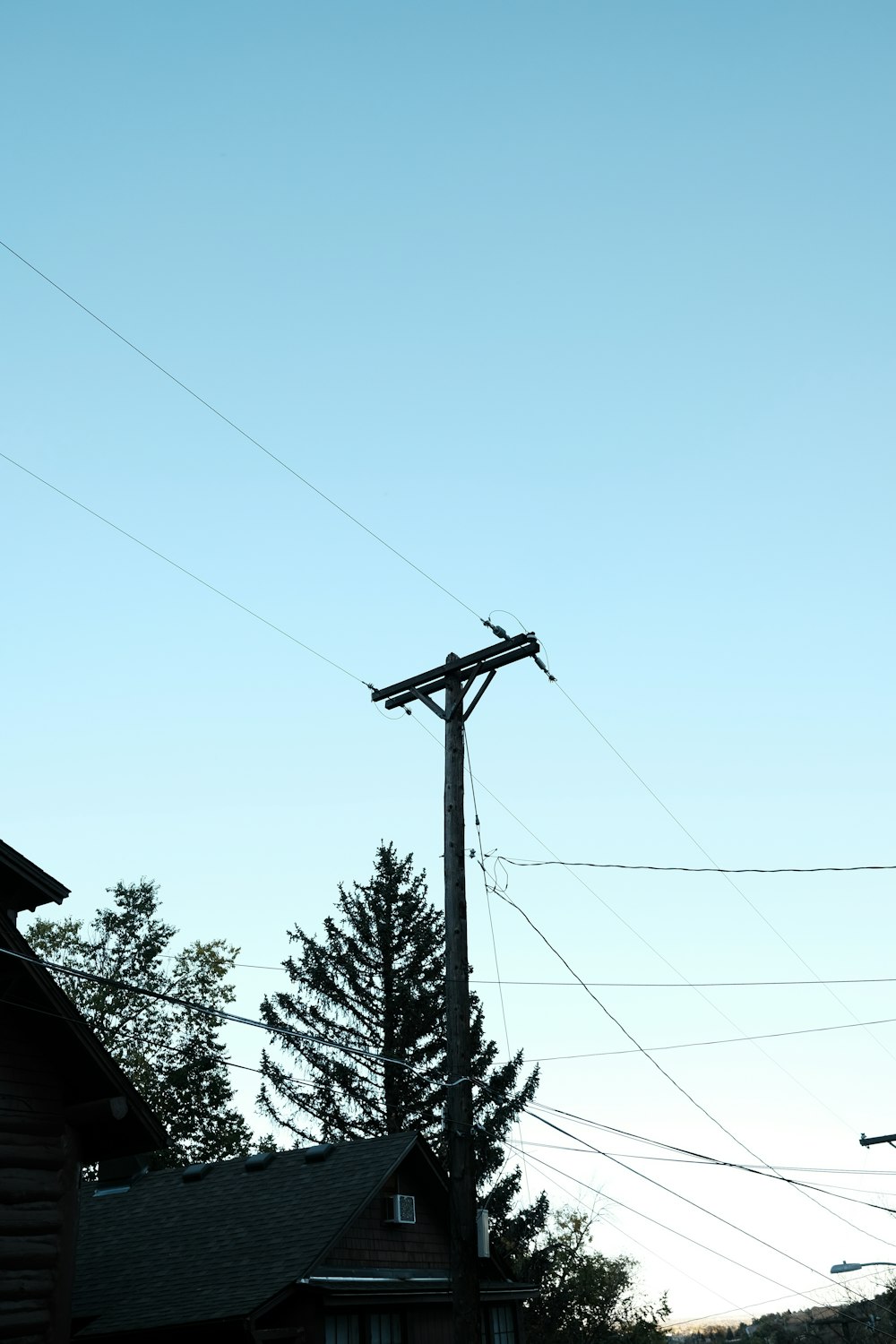 a telephone pole in the middle of a neighborhood