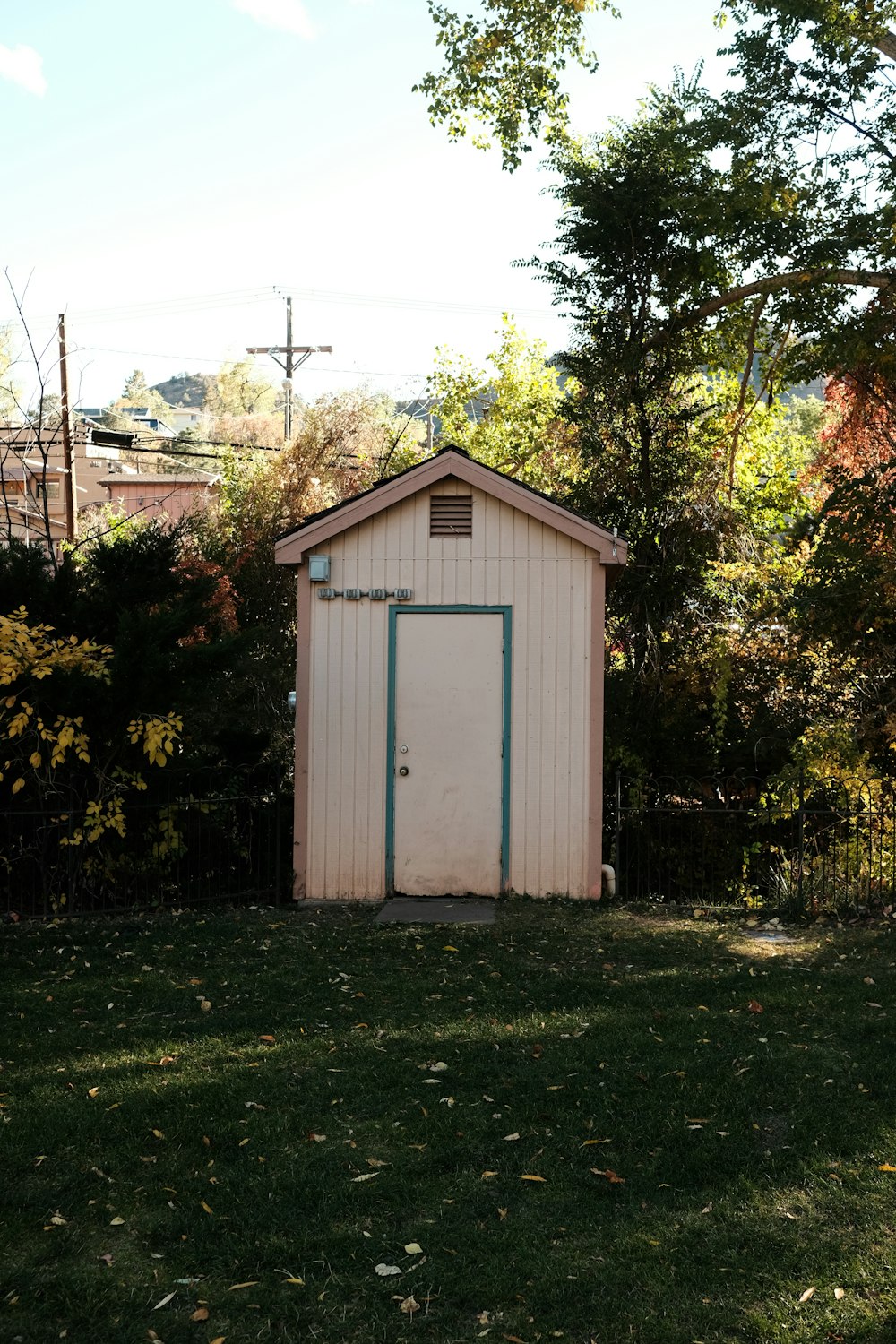 a small shed sitting in the middle of a yard