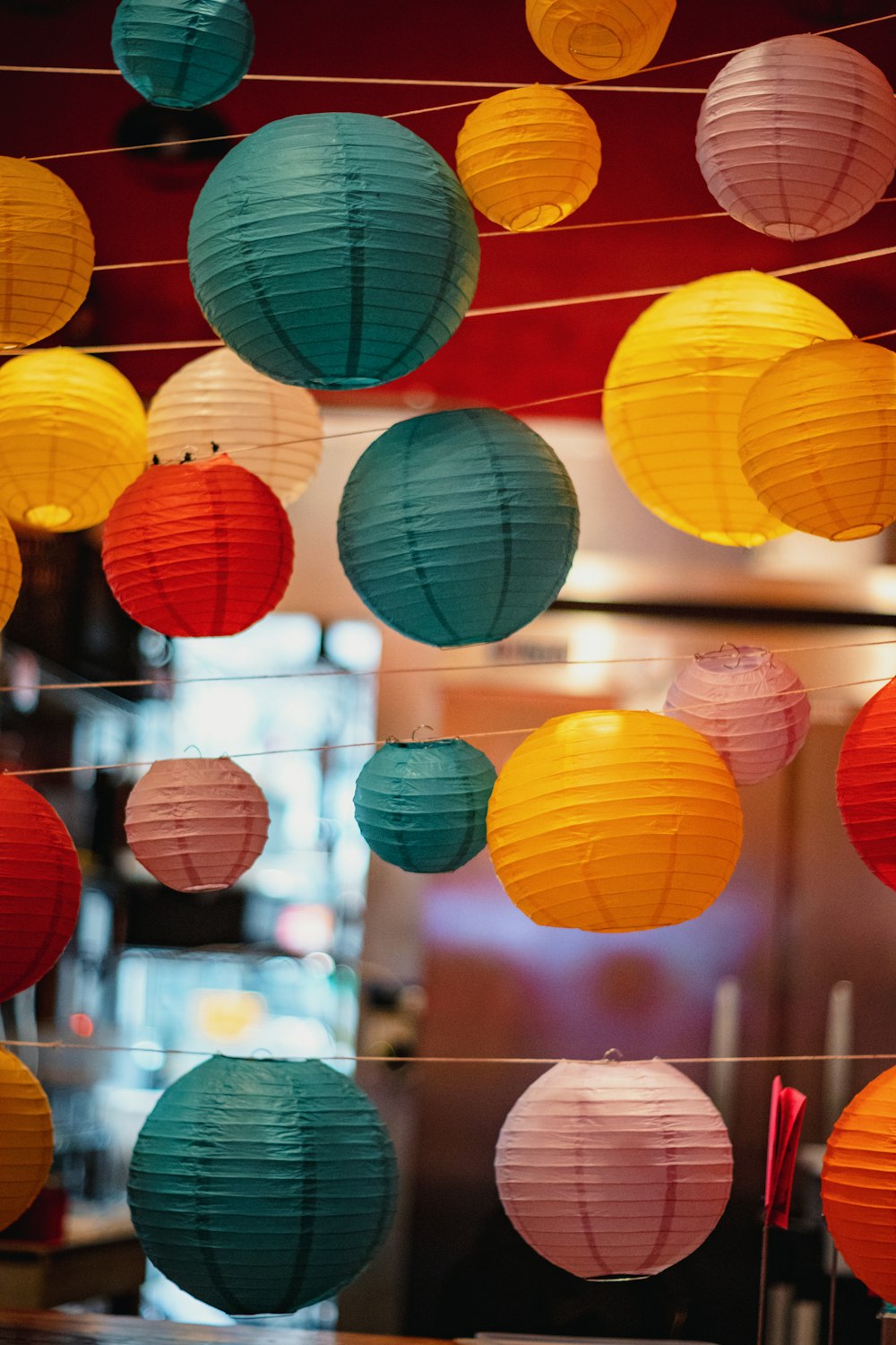 a bunch of paper lanterns hanging from a line