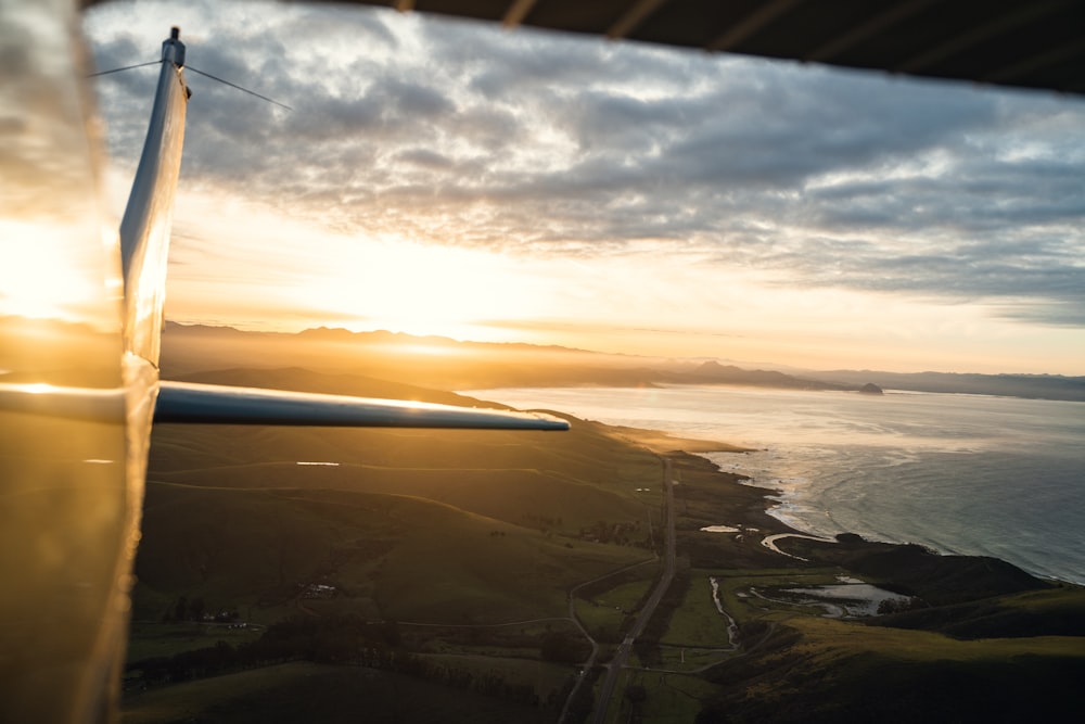 a view from a plane of a sunset over a body of water