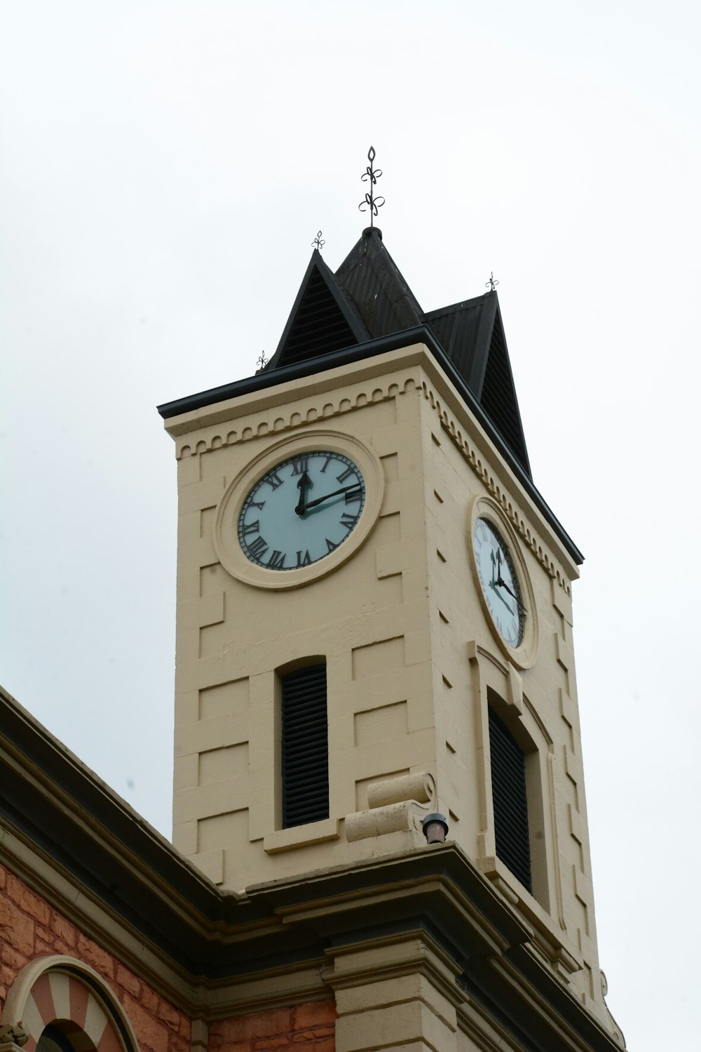 a clock tower with two clocks on each of it's sides