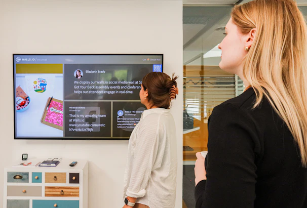 a woman standing in front of a flat screen tv