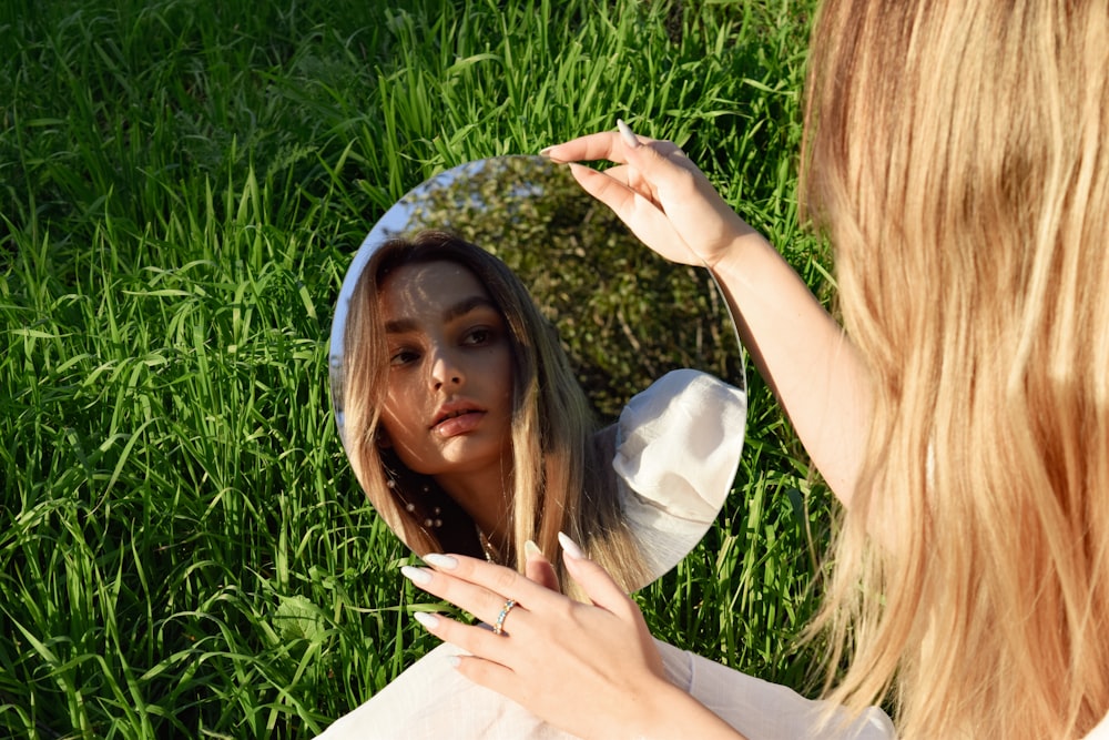 a woman looking at her reflection in a mirror