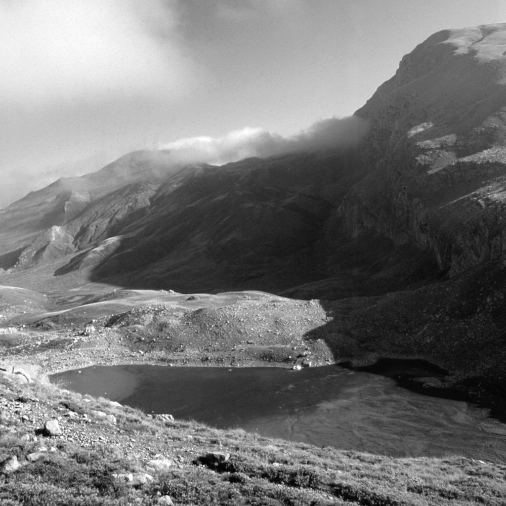 a black and white photo of a mountain range