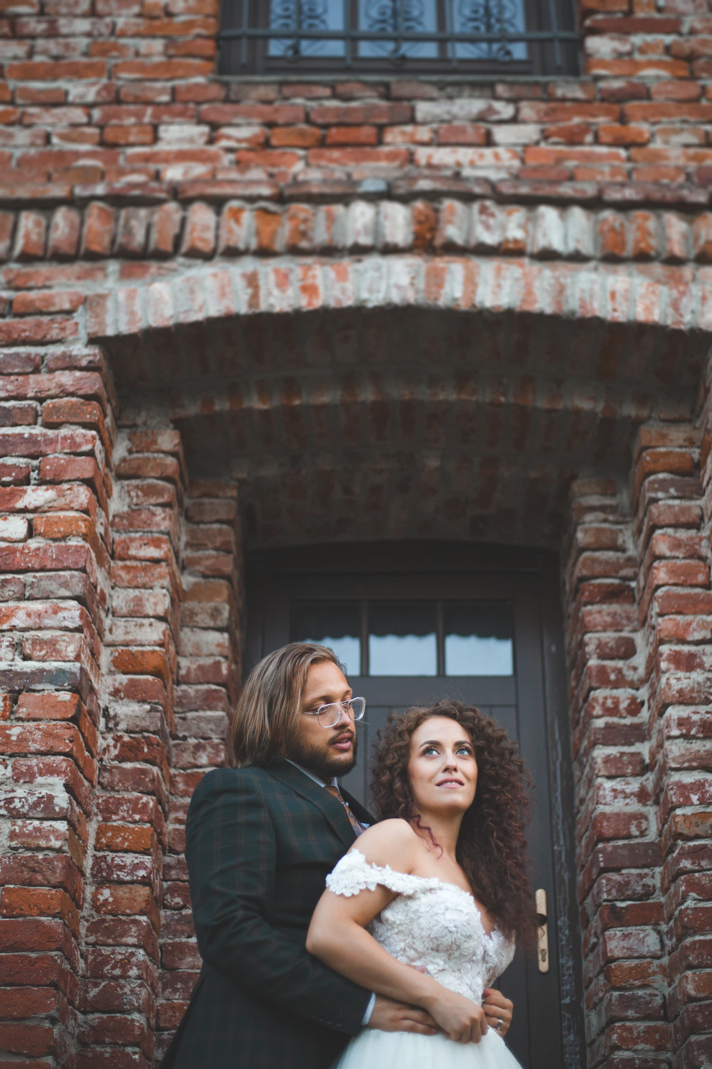 Wedding couple sharing an intimate close moment together outdoors in soft natural light during portrait session