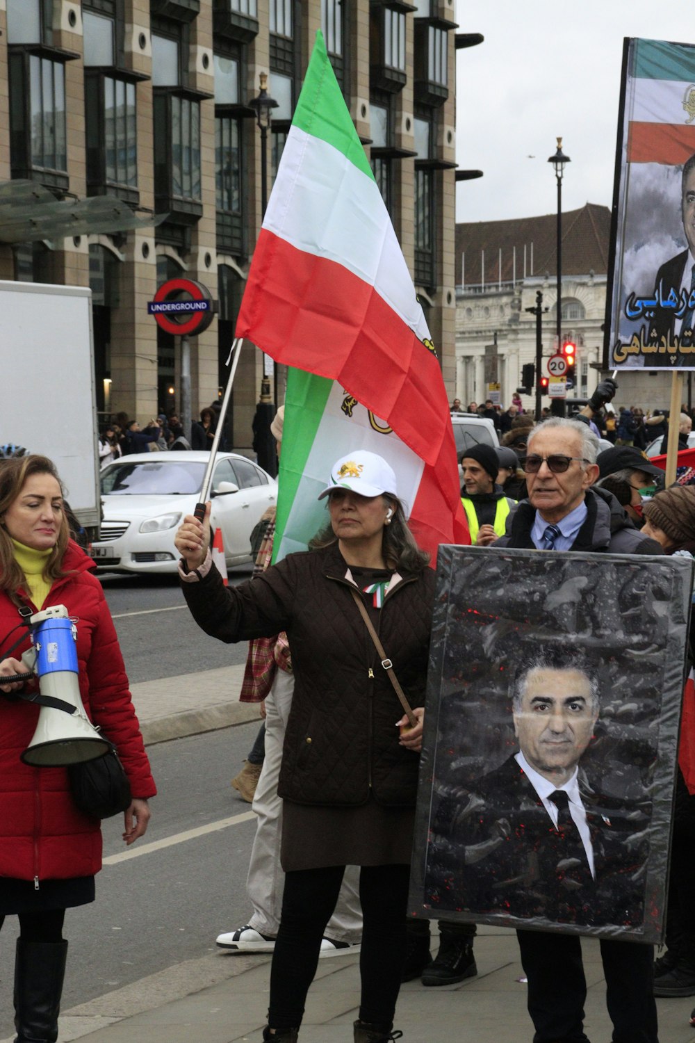 a group of people holding signs and flags