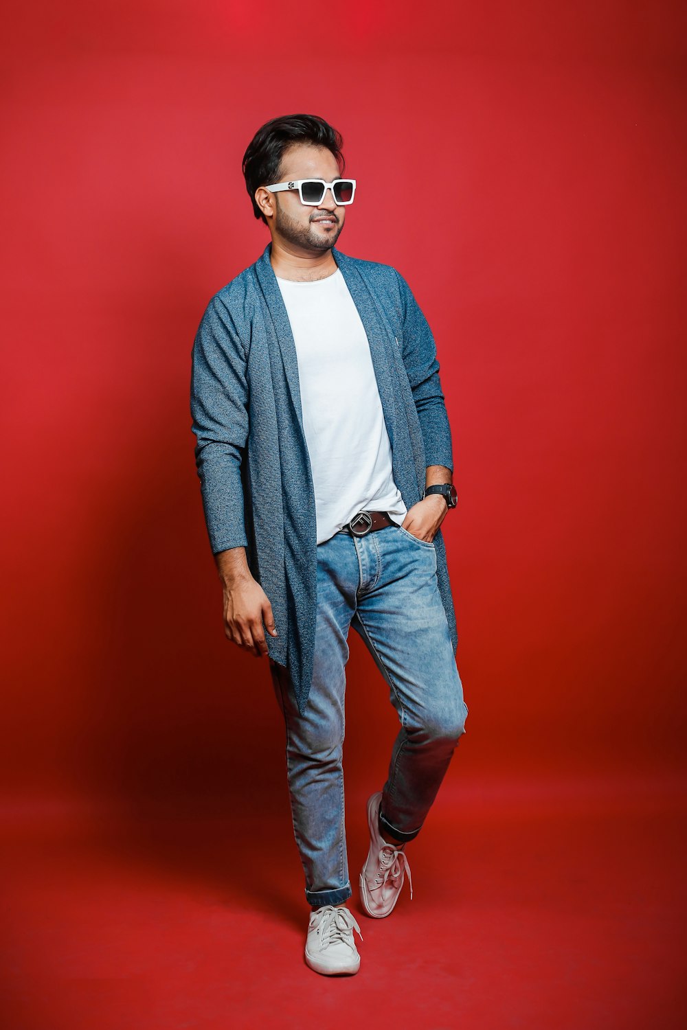 a man standing in front of a red background