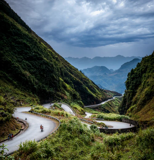 Riders on a winding mountain road
