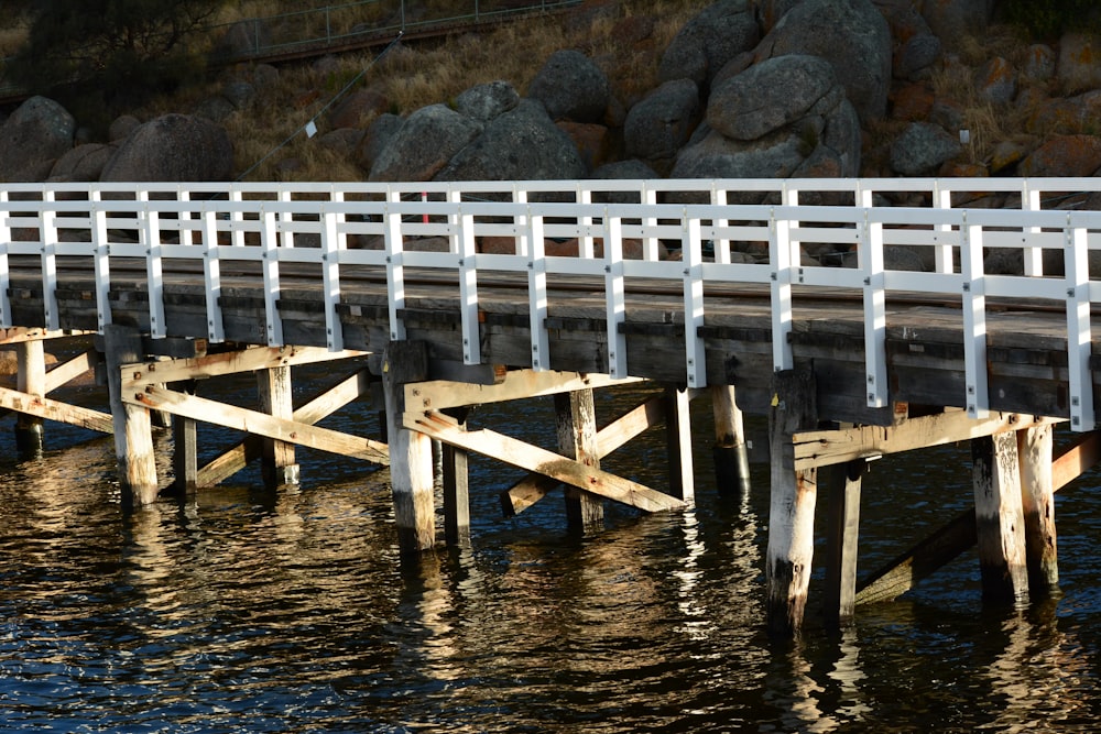 a white wooden bridge over a body of water
