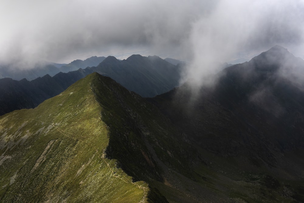 a view of a mountain range with clouds in the sky