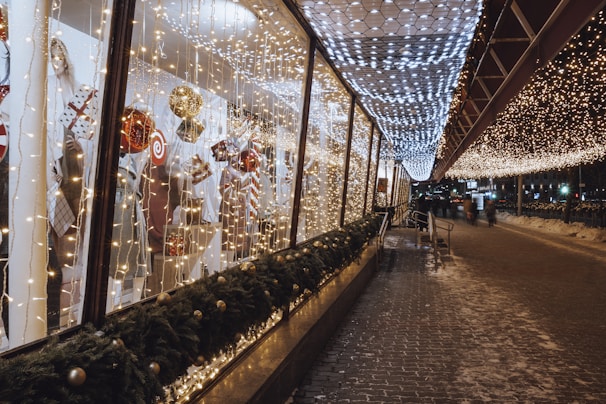 An artistic arrangement of colorful holiday lights on a storefront.