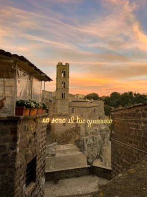 Lorenzo Muscoso directing a scene outdoors in a rustic Sicilian village at sunset, embodying the spirit of Verga’s world.
