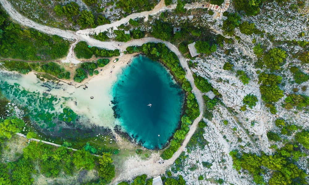 an aerial view of a lake surrounded by trees