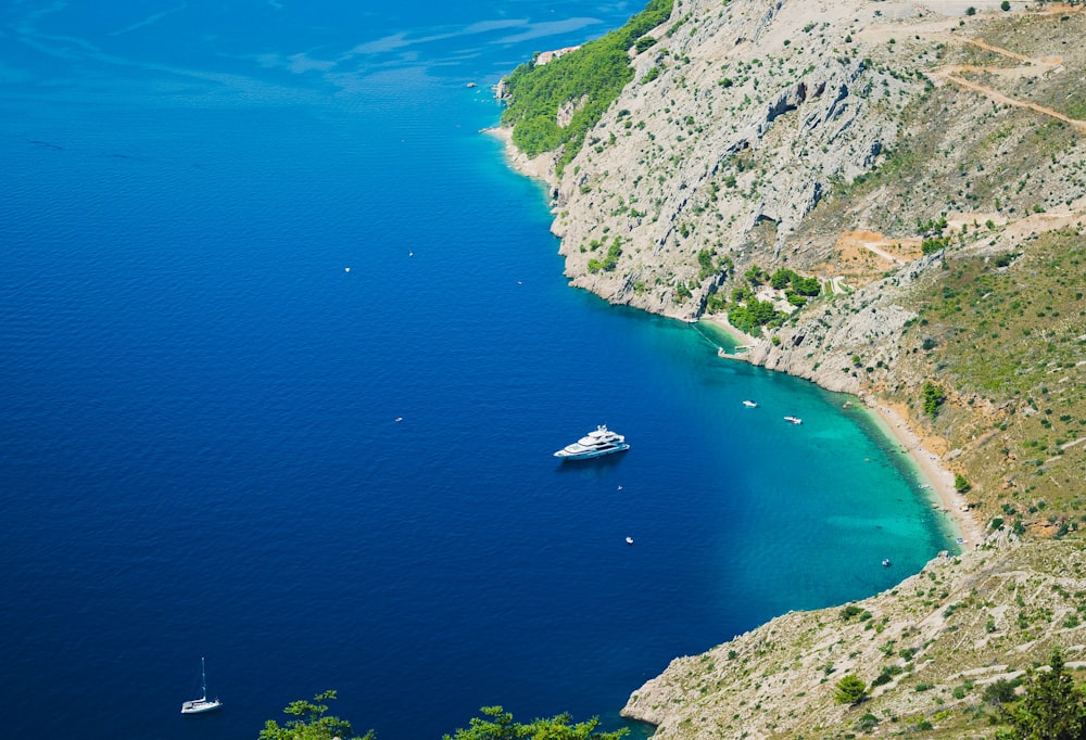 a boat in a body of water near a mountain