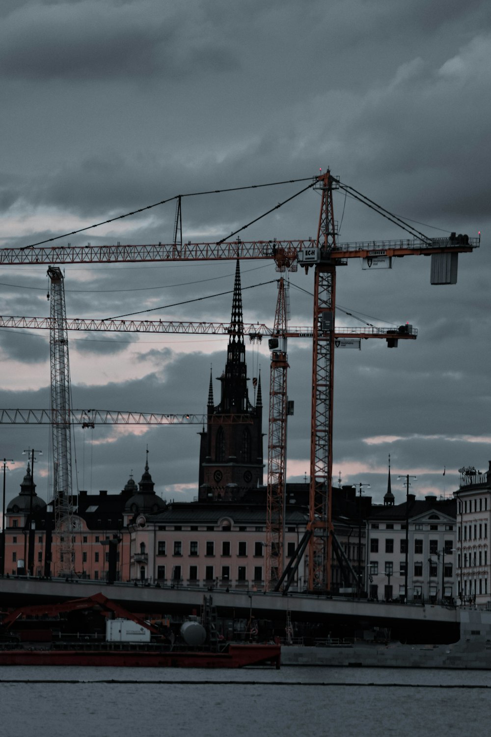 a large crane sitting on top of a building next to a body of water